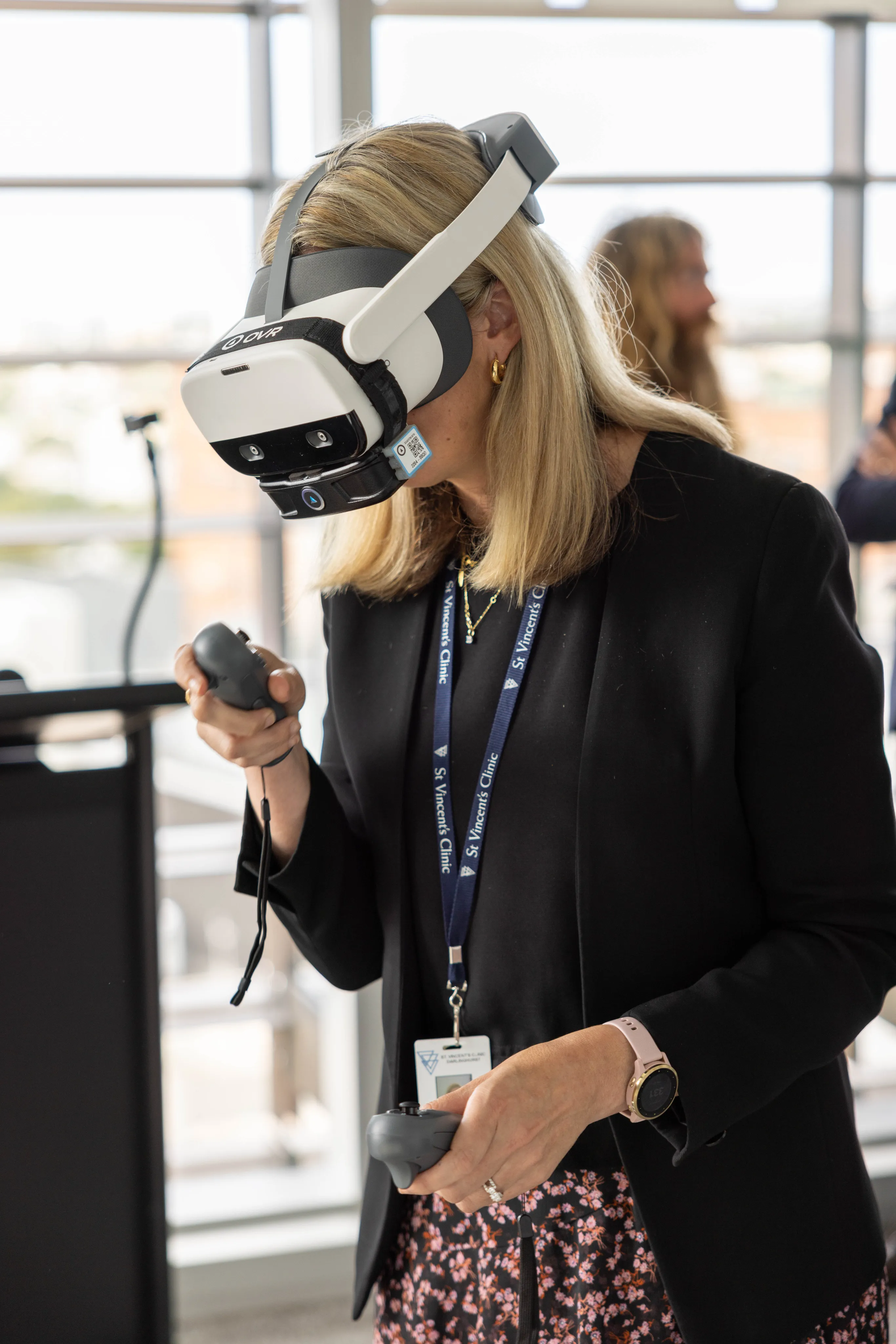 A clinician guiding a patient wearing an immersive therapy headset
